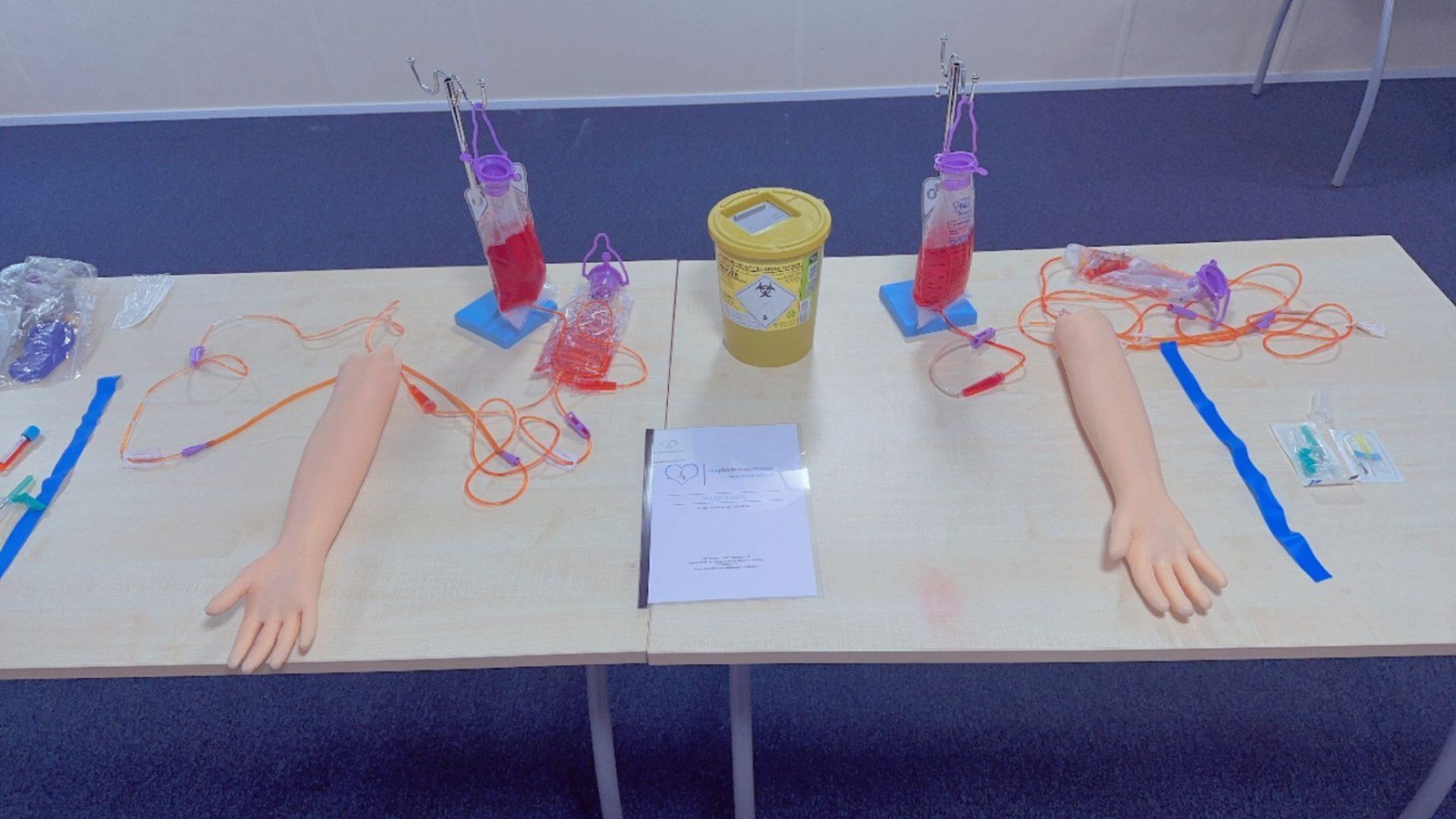 Phlebotomy trainer working one-on-one with a student